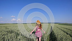 Beautiful Young Woman jumping on green wheat field