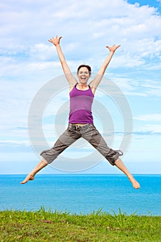 Beautiful young woman jumping and laughing