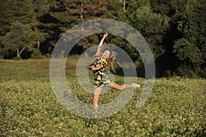 Beautiful young woman jumping in meadow