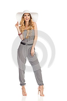 Beautiful Young Woman In Jumpsuit, Sun Hat And High Heels. Full Length.