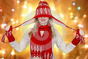 Beautiful young woman in a beautiful knitted hat, mitten and scarf. Fashionable knitted clothes.Merry Christmas and Happy Holidays