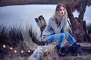 Beautiful young woman by the lake