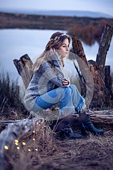 Beautiful young woman by the lake
