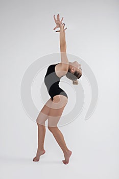 Beautiful young woman limber exerciser in the studio