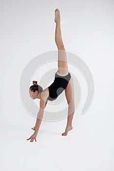 Beautiful young woman limber exerciser in the studio