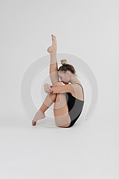 Beautiful young woman limber exerciser in the studio