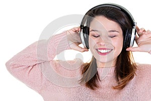 Beautiful young woman listen music with headphones on white