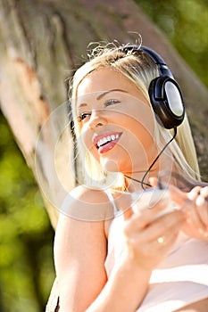 Beautiful young woman listening to her mp3 player