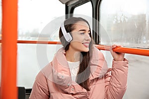 Beautiful young woman listening to music with headphones