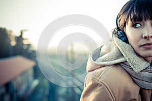 Beautiful young woman listening to music headphones