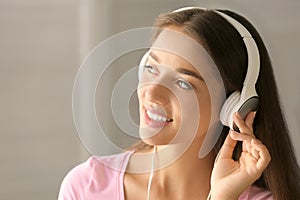 Beautiful young woman listening to music at home