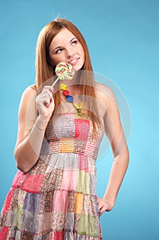 Beautiful young woman with lollipop