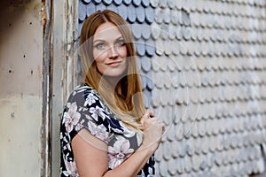 Beautiful young woman with long hairs in summer dress going for a walk in German city. Happy girl enjoying walking in