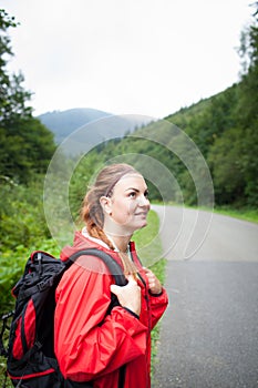 Beautiful young woman looking around and watching nature