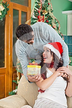 Beautiful Young Woman Looking Gift Box and Smiling While Her Boy