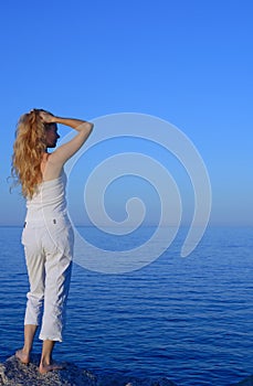 Beautiful young woman looking at the sea