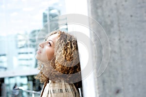 Beautiful young woman looking up