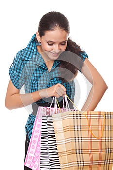 Beautiful young woman looks bag shopping