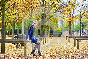 Beautiful young woman in the Luxembourg garden of Paris on a fall day