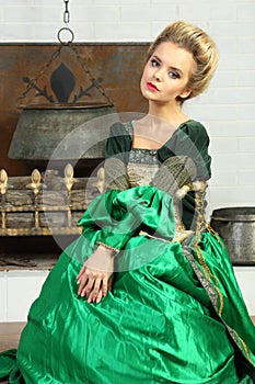 Beautiful young woman in luxury green medieval