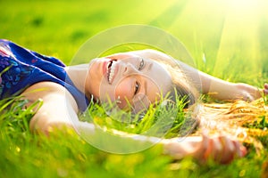 Beautiful young woman lying on the field
