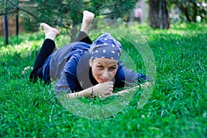 Beautiful young woman lying in the grass