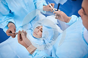 Beautiful young woman lying on operating table