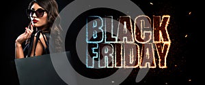 Black friday sale concept. Shopping woman holding grey bag isolated on dark background in holiday. Neon lights.