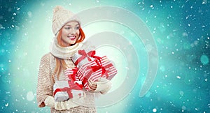 Shopping woman holding gift boxes on winter background with snow in black friday, Christmas and New Year holidays. Sale