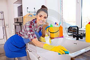 Beautiful young woman makes cleaning the house. Girl cleaning kitchen. Set.