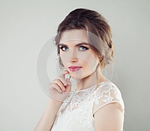 Beautiful young woman with makeup and bridal hairstyle. Pretty girl bride, face closeup