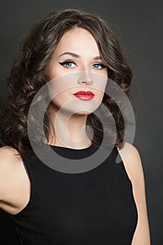 Beautiful young woman with makeup and curly hair closeup portrait