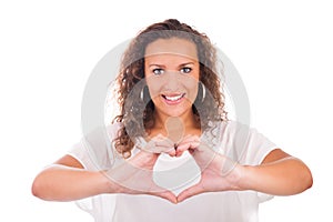 Beautiful young woman making a heart with hands