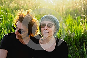 Beautiful young Woman and man together in park. Sunny day, sunset. Outdoor hipster couple