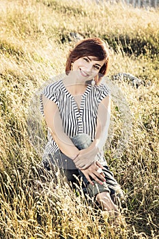 Beautiful young woman in the meadow, female portrait