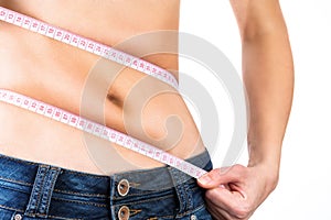 Beautiful young woman measuring her waist ,isolated on white background.