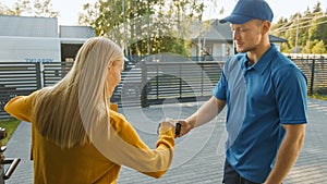 Beautiful Young Woman Meets Delivery Man who Gives Her Cardboard Box Package, She Signs Electronic