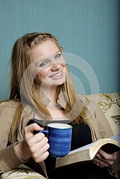 Beautiful Young Woman with morning coffee and bibl
