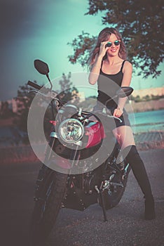 Beautiful young woman mount on motorcycle