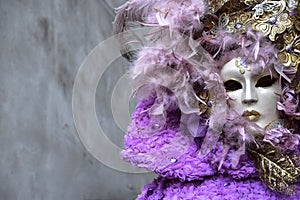 Beautiful young woman with mysterious colors Venetian mask. Fashion photo. Holidays and celebrations photo