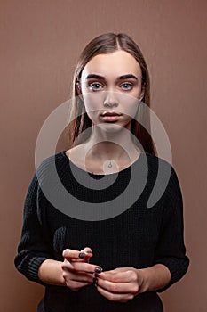 Beautiful young woman mysteriously looks into the frame