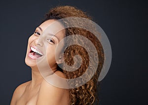 Beautiful young woman with naked shoulders laughing photo