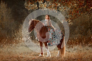 Beautiful young woman in national russian style with red draft horse