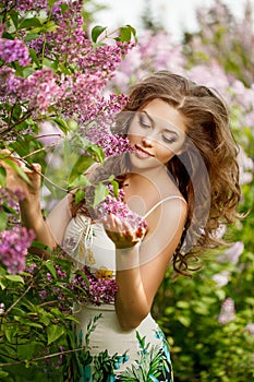 Beautiful Young Woman near the Blossoming spring tree. Model in blossom park