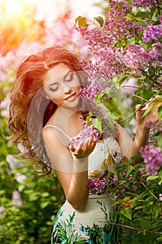 Beautiful Young Woman near the Blossoming spring tree. Model in blossom park