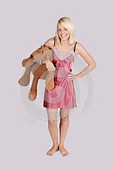 Beautiful young woman in nightie with teddy bear