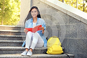 Beautiful young woman with notepad