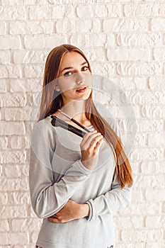 Beautiful young woman with nude face makeup with brushes for makeup