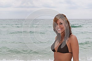 Beautiful young woman with ocean in background