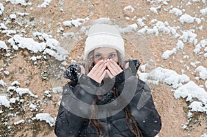 Beautiful young woman outside while its snowing